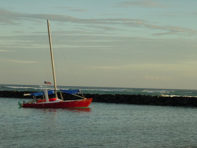 Sailing ship on the lake with the ocean just behind