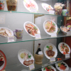 Window of a Japanese restaurant, fake (wax) food in display