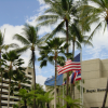 Blue sky over O'ahu: Palm trees, flags of the Sheraton, America and Hawaii