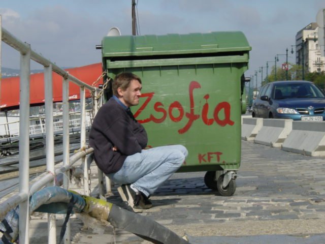Max shielded from the cold wind by the trash container of the Zsofia boat