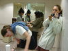 Mirror project: Carine and I in the restrooms and two girls, one massaging the hand of the other with oil