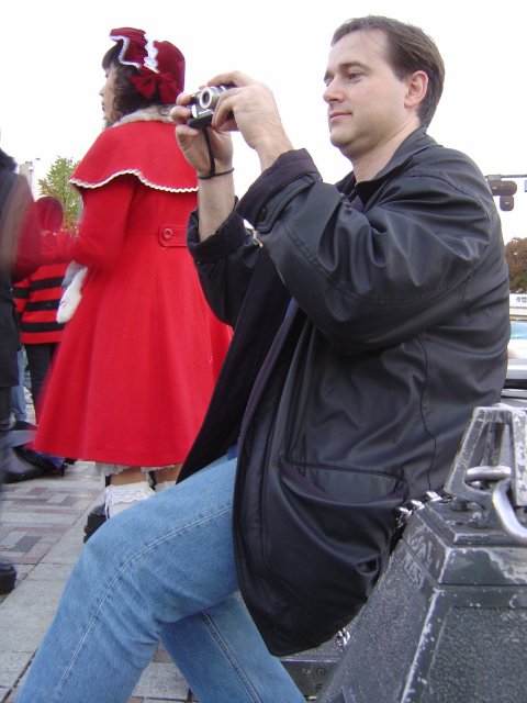 Yves holding his camera, costume girl behind him