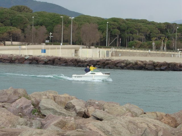 Motor boat on the river towards the sea