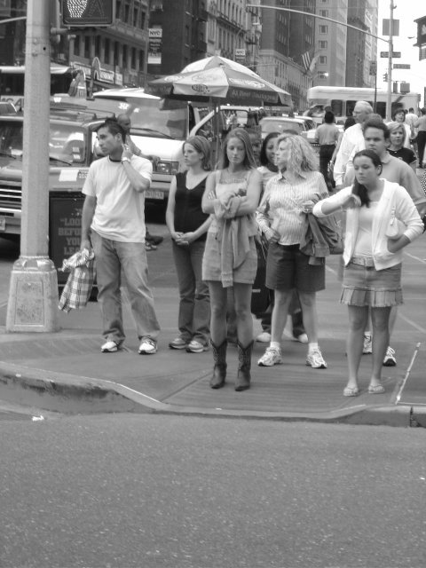 "Fashion" several people waiting by the crossing all featuring a different fashion