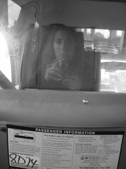 My reflection in the taxi separation window