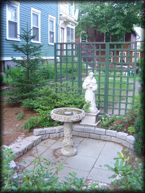 Saint Francis in a garden, next to a fountain