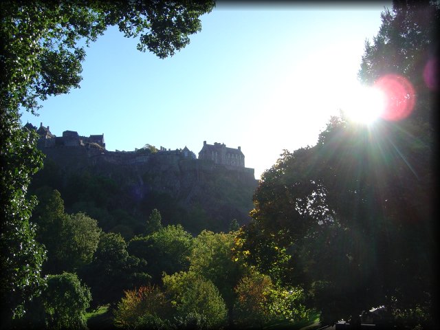 Edinburgh Castle between trees in Princes Street Gardens