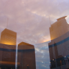 Three buildings reflected in the glass door of 1000 la gauchetiere.