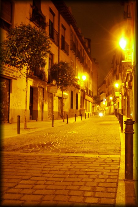 A deserted paved street at night