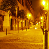 A deserted paved street at night