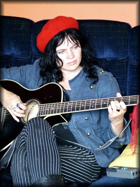 In the common room at the Old Monastery Hostel, Wendy settled on the couch, played the guitar and sang.
