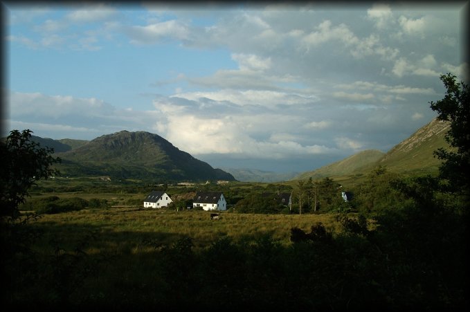 Clouds and blue sky, mountains, fields, houses.