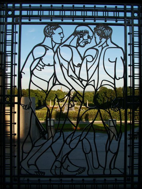 Wrought iron gate at the Vigeland Sculpture Park featuring three naked men on their way. Left pane.