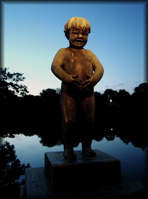 This is a night shot! (00:24) It just doesn't get quite dark in Olso right now.  Sculpture of a hungry-looking boy on the bridge in the Vigeland Sculpture Park.