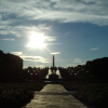 Paved path among flowers, fountain and Monolith (over 14 meter tall column with human bodies carved out of a single block of stone) in the Vigeland Sculpture Park.