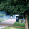 Boy running in the Vigeland Sculpture Park, just behind smoke that comes from the special container for engangsgrills.