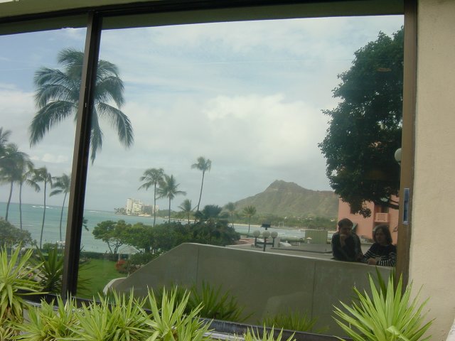 Reflection of Carine, Yves and Diamond Head on a window