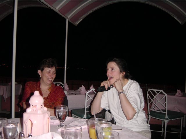 At the restaurant: Marie-Claire laughing and Janet covering her ears