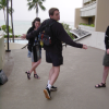 Max performing a model walk, Christelle and Hugo watching and laughing in the back