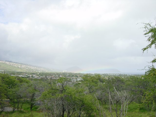 Long and flat rainbow on the ocean, view from the foot of Diamond Head