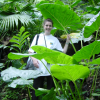 Coralie holding a large umbrella-like leaf