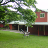 Red wooden barns, a wooden horse