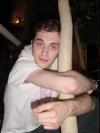 Olivier clanging to a tree trunk late at night