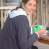 Coralie writing postcards from Akaroa