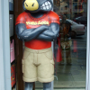 A Toro Loco statue guarding the entrance of a shop. Reflection of Isabelle in the window next to it.