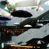 Umbrellas dangling from the ceiling in a mall.